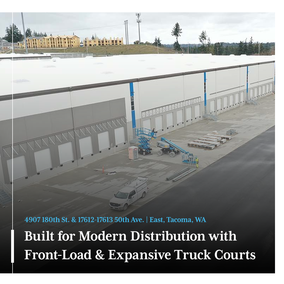 Close-up view of a modern building's exterior with glass and metal architectural details against a clear blue sky.