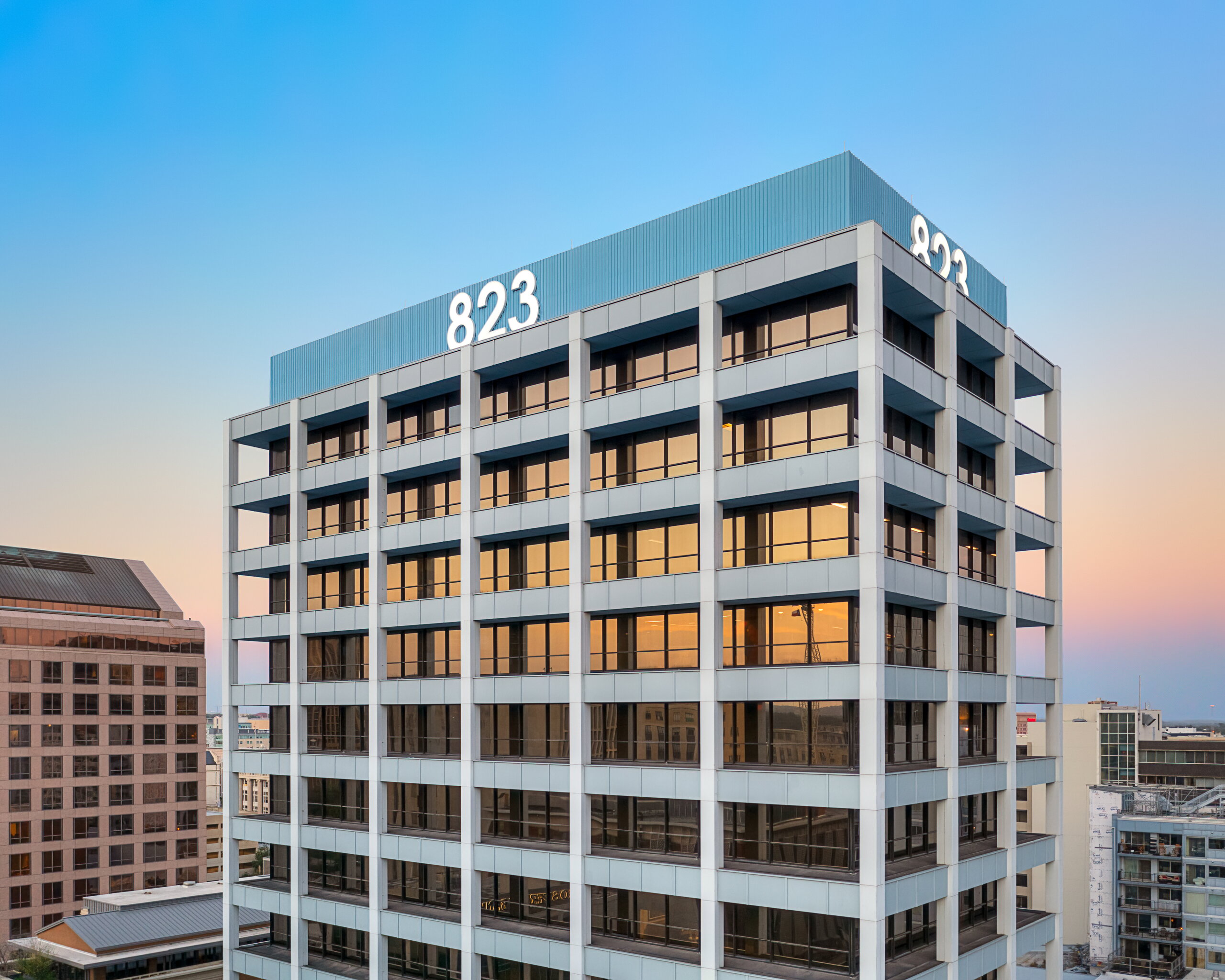 High-rise office building with signage showing 823