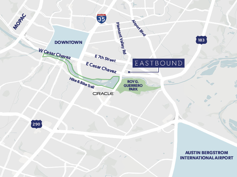 Exterior view of a modern commercial building with landscaping and people walking near the entrance