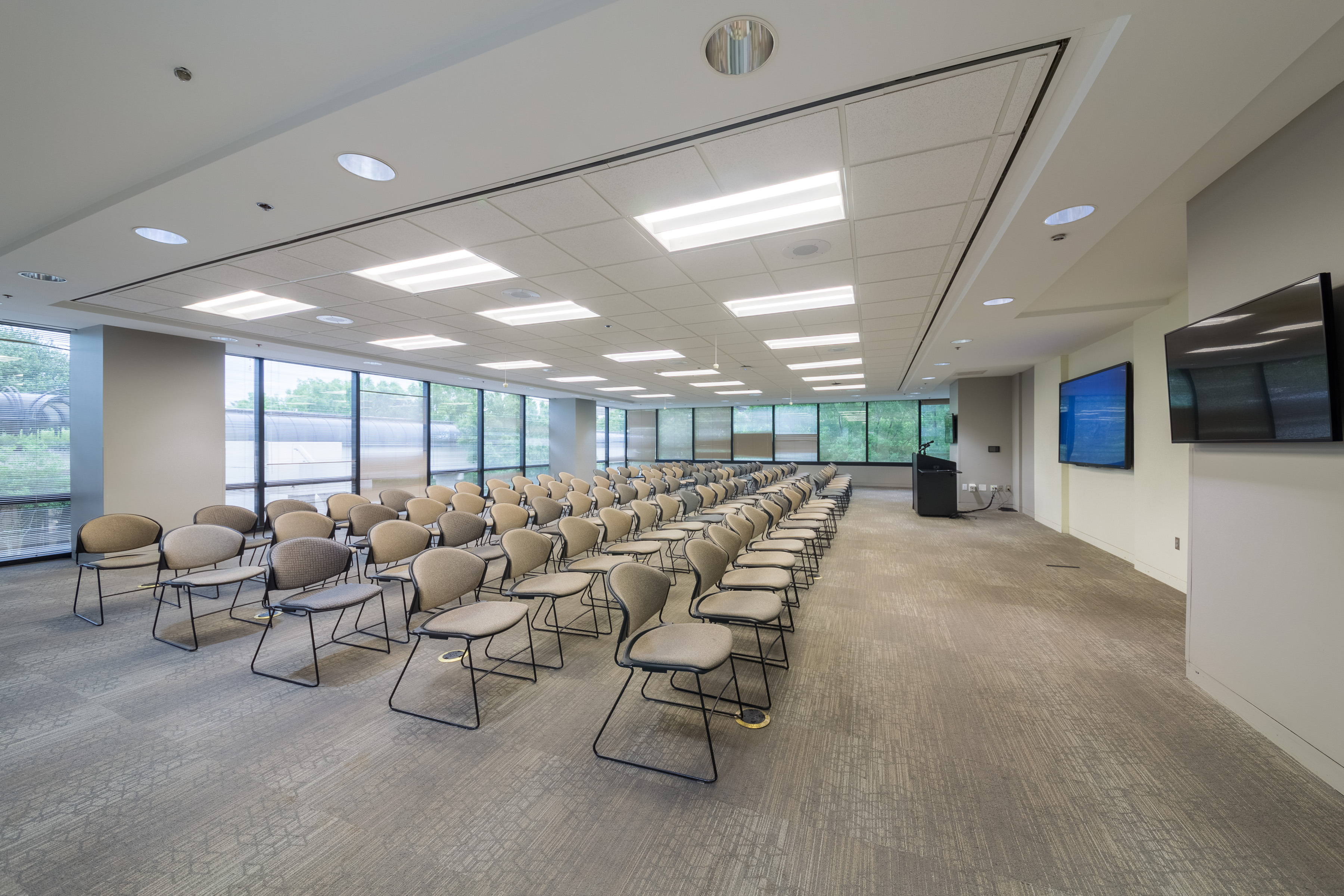 Modern conference room with wooden table and green chairs